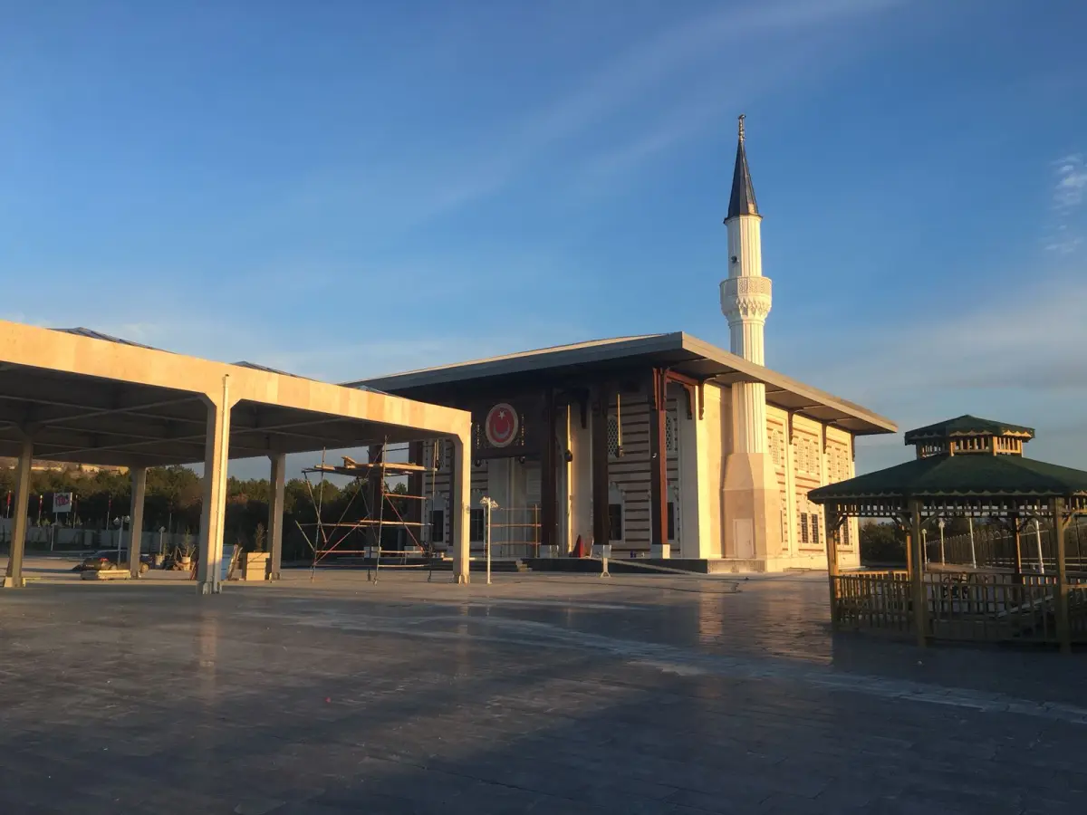Caminin taş döşeli avlusu, gölgelik alanı ve minaresinin genel görünümü